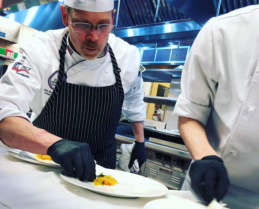 Chef Bucci preparing a dish at the CMC competition